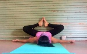 A girl doing yoga poses with wall